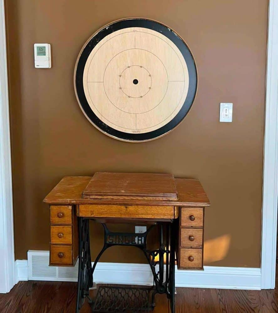 Black Tracey board hung above wooden desk