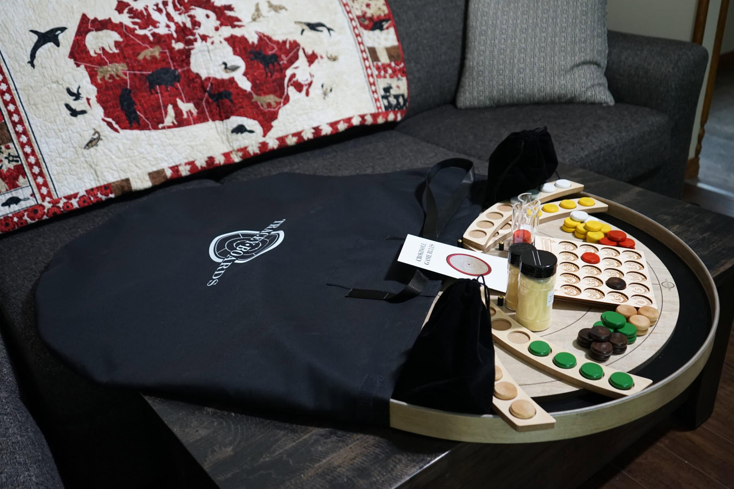 A grey rock board with a crokinole carry bag